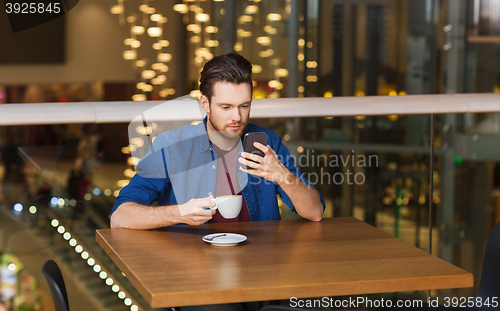 Image of man with smartphone and coffee at restaurant