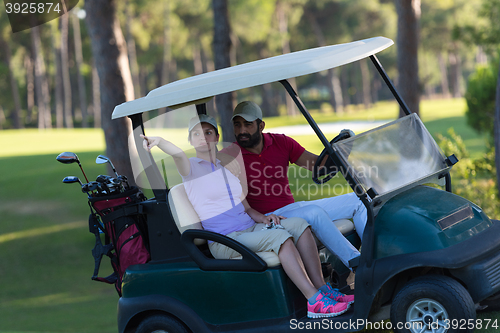 Image of couple in buggy on golf course