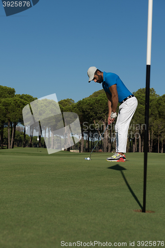 Image of golf player hitting shot at sunny day