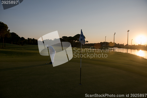 Image of golfer hitting ball to hole