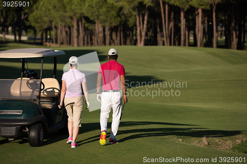 Image of couple walking on golf course