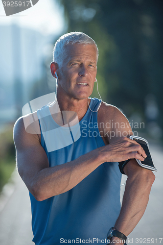 Image of portrait of handsome senior jogging man