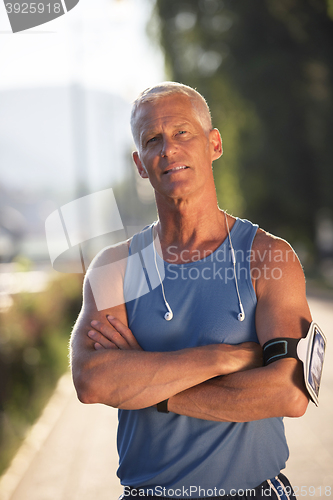 Image of portrait of handsome senior jogging man