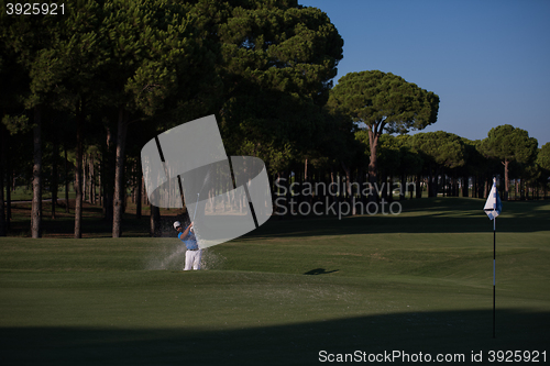 Image of pro golfer hitting a sand bunker shot