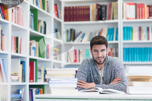 Image of portrait of student while reading book  in school library