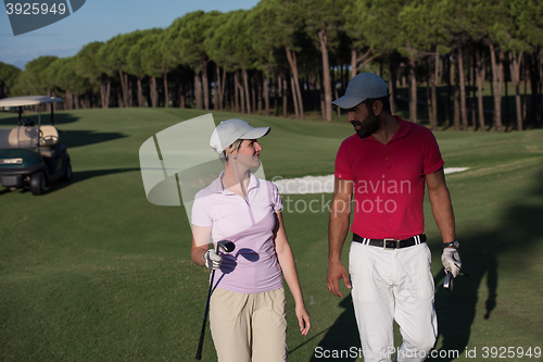 Image of couple walking on golf course