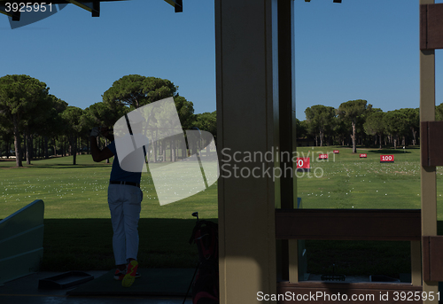 Image of golf player practicing shot on training