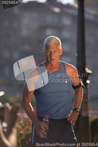 Image of portrait of handsome senior jogging man