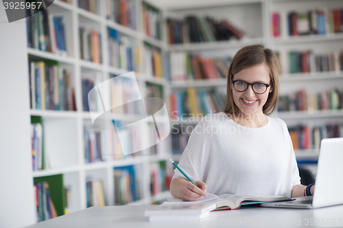 Image of female student study in school library