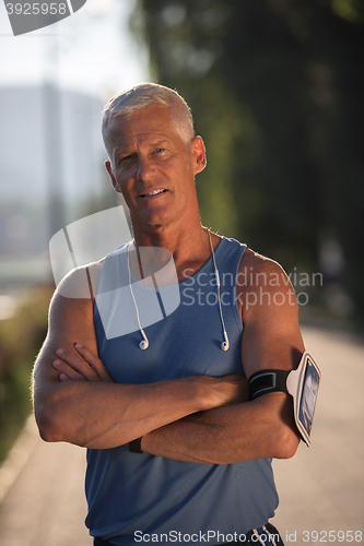 Image of portrait of handsome senior jogging man