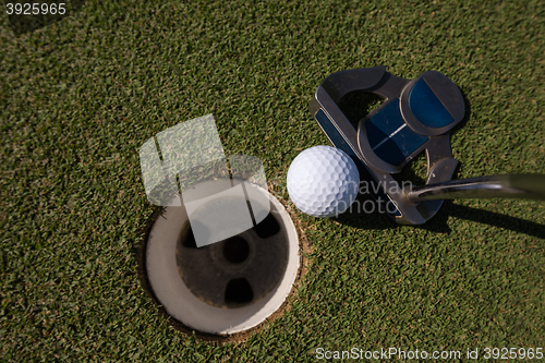 Image of hitting golf ball to hole