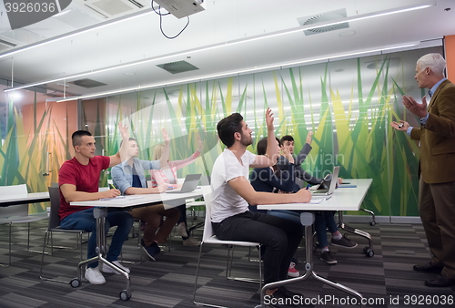 Image of teacher with a group of students in classroom