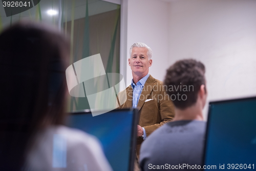 Image of teacher and students in computer lab classroom