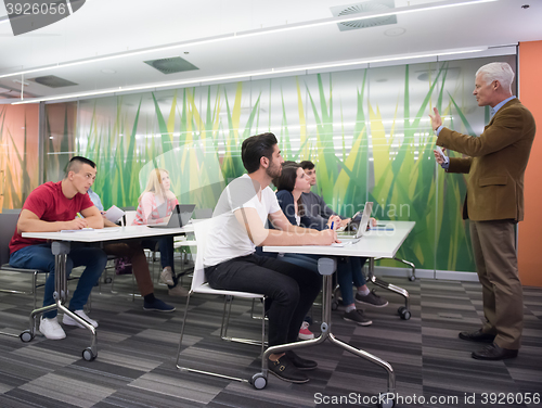 Image of teacher with a group of students in classroom