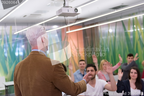 Image of students group raise hands up