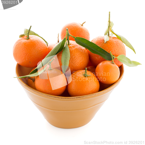 Image of Tangerines on ceramic yellow bowl 