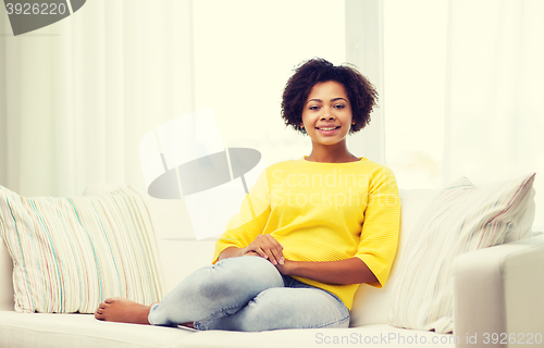 Image of happy african american young woman at home