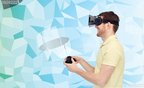 Image of happy man in virtual reality headset with gamepad