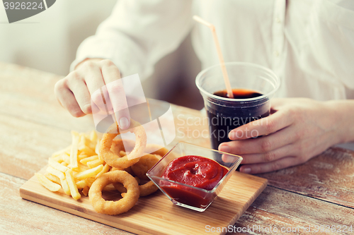 Image of close up of woman with snacks and cola