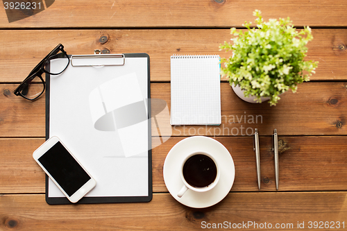 Image of close up of coffee, clipboard and notepad