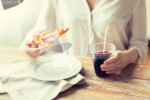 Image of close up of woman with pizza and cola drink