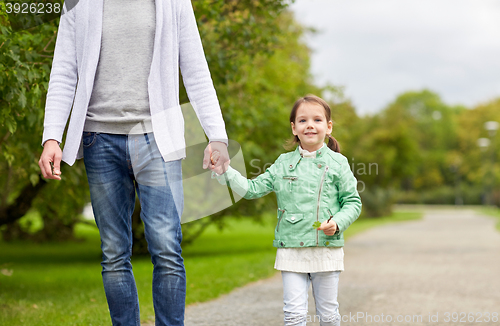 Image of close up of father and little girl walking in park