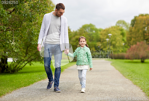 Image of happy family walking in summer park