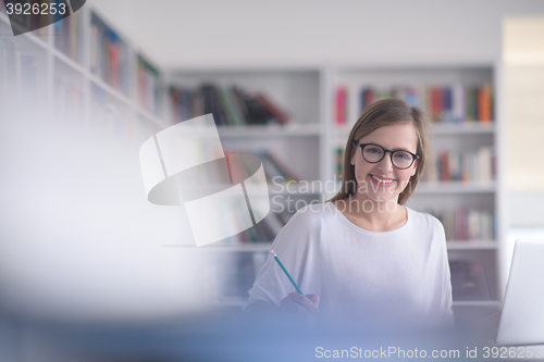 Image of female student study in school library