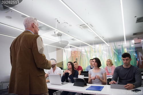Image of teacher with a group of students in classroom