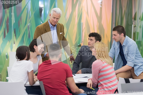 Image of teacher with a group of students in classroom