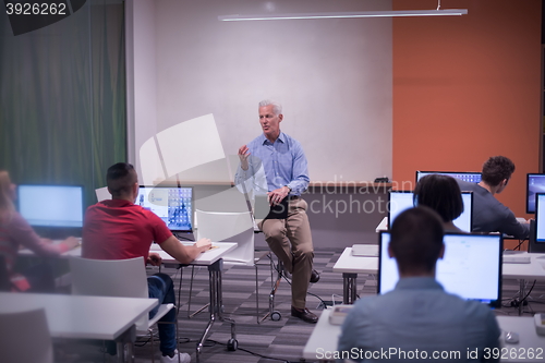 Image of teacher and students in computer lab classroom