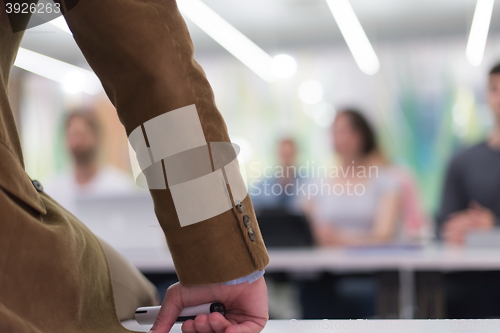 Image of close up of teacher hand while teaching in classroom