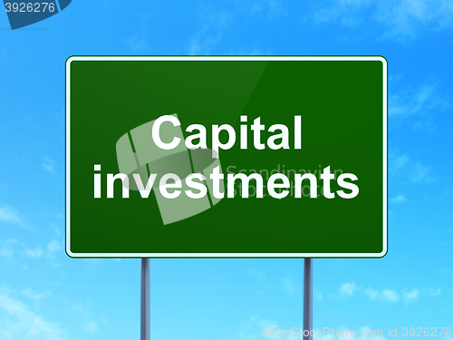 Image of Currency concept: Capital Investments on road sign background