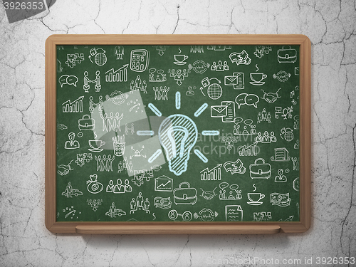 Image of Business concept: Light Bulb on School board background