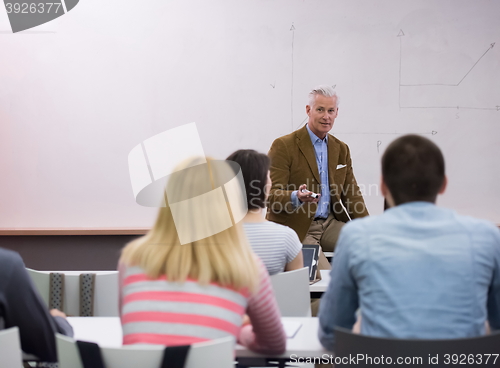 Image of teacher with a group of students in classroom