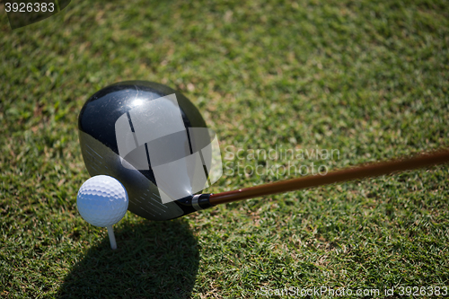 Image of top view of golf club and ball in grass