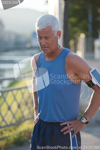 Image of portrait of handsome senior jogging man