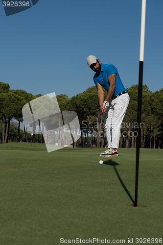 Image of golf player hitting shot at sunny day