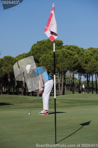 Image of golf player hitting shot at sunny day