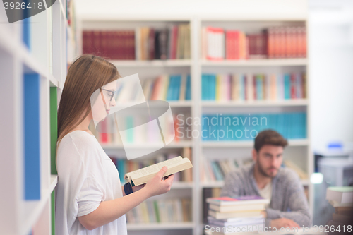 Image of students couple  in school  library