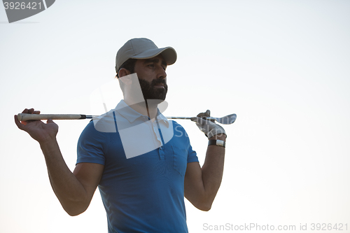 Image of golfer  portrait at golf course on sunset