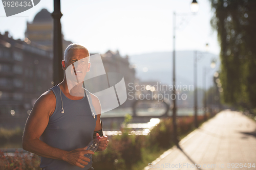 Image of portrait of handsome senior jogging man