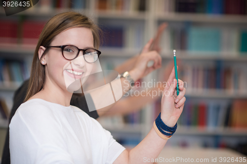 Image of group of students  raise hands up