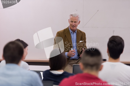 Image of teacher with a group of students in classroom