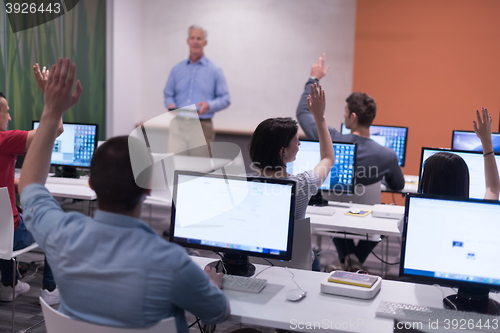 Image of teacher and students in computer lab classroom