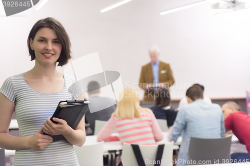 Image of portrait of happy female student in classroom