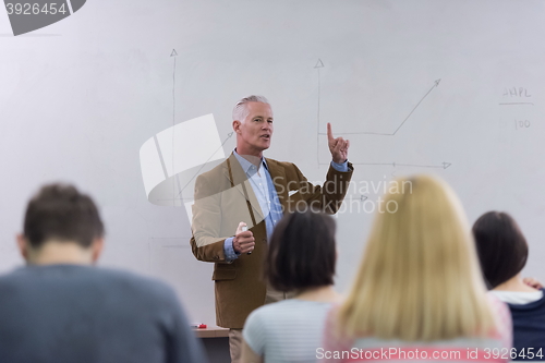 Image of teacher with a group of students in classroom