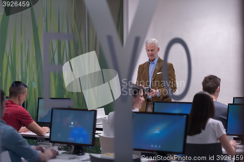 Image of teacher and students in computer lab classroom
