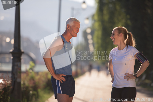 Image of jogging couple planning running route  and setting music