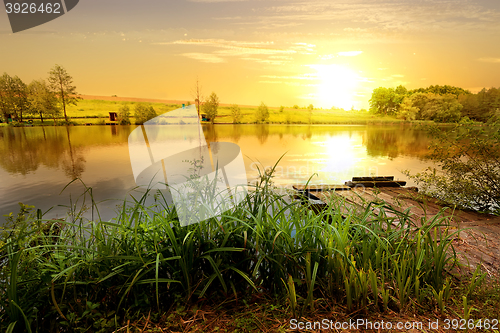 Image of Yellow sunset on pond